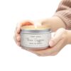 Christian coffee-scented candle for gifts held by a woman, emitting a warm coffee aroma.